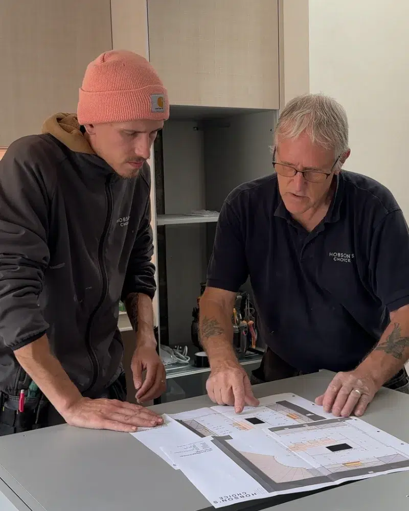 Hobson's Choice installers reviewing mechanical and electrical drawings during a kitchen installation