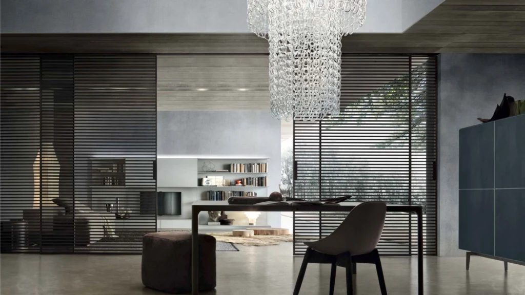 Rimadesio Stripe sliding doors with black aluminium cross-members dividing a contemporary living and dining space