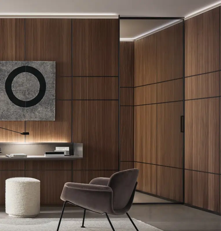 Rimadesio clear Velaria swing door in a room with Rimadesio Modular wall panelling