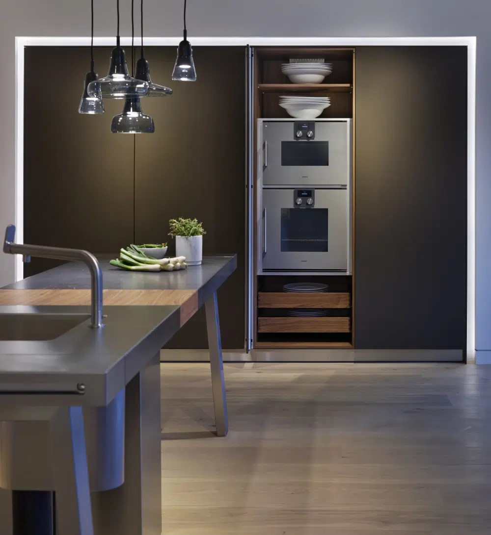 Open bulthaup b2 appliance cabinet with integrated ovens and storage