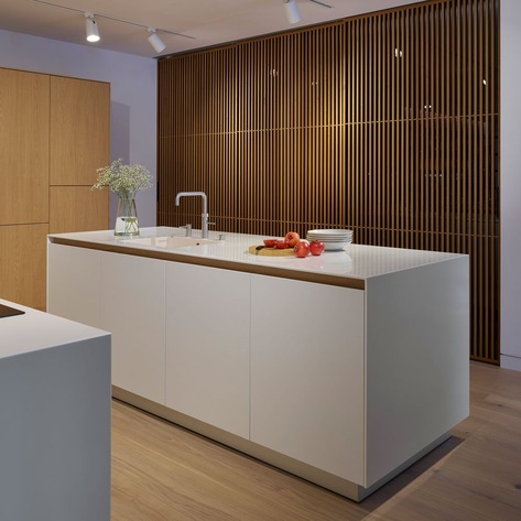 A bulthaup b3 kitchen island with Rimadesio sliding Sail door behind at our Wiltshire studio