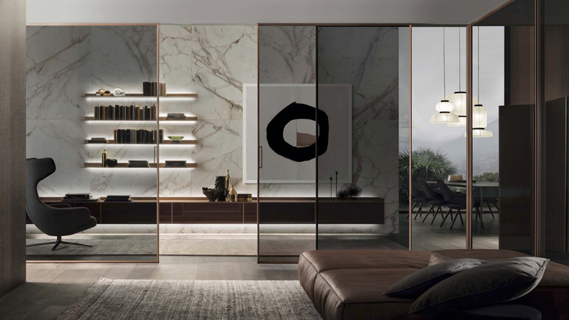 Rimadesio Velaria floor-to-ceiling glass sliding doors separating a dining area from a contemporary living room.
