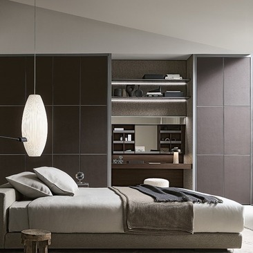 Dark, fitted Rimadesio bedroom storage and open shelving framing a low bed.