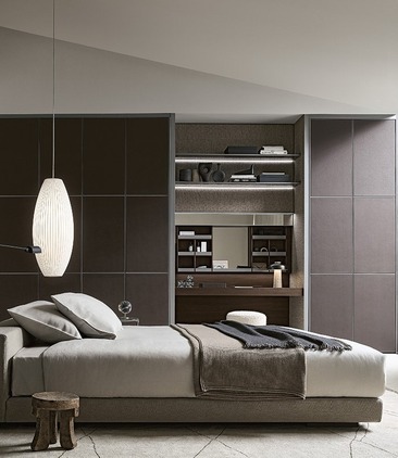 Dark, fitted Rimadesio bedroom storage and open shelving framing a low bed.