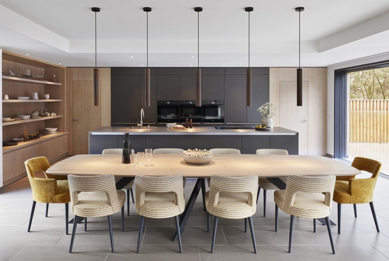 Contemporary kitchen and dining space overlooking a secluded wooded garden