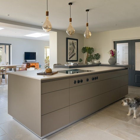 Open plan bulthaup kitchen dining area with a dog in the foreground