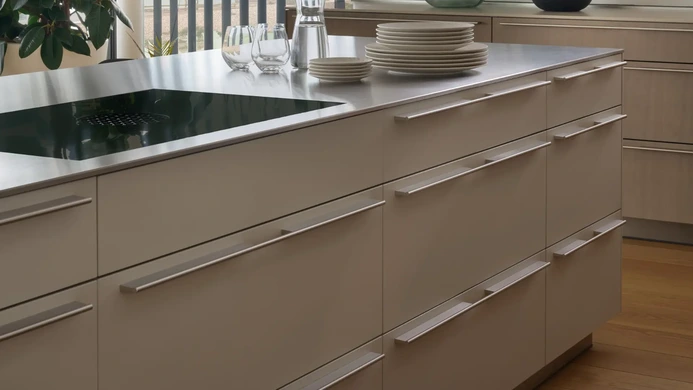 Gravel laminate kitchen island with stainless steel preparation surface