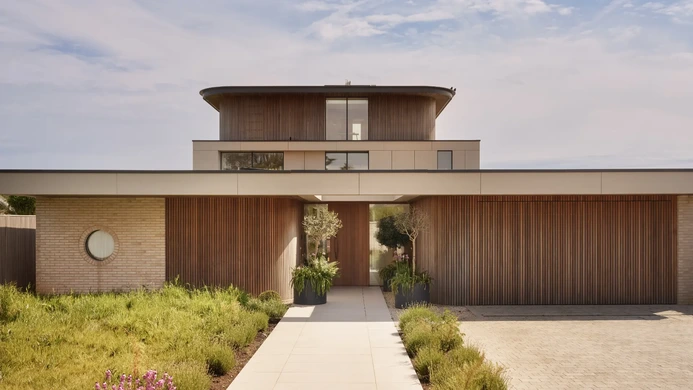 Contemporary South Coast home with timber cladding and landscaped entrance