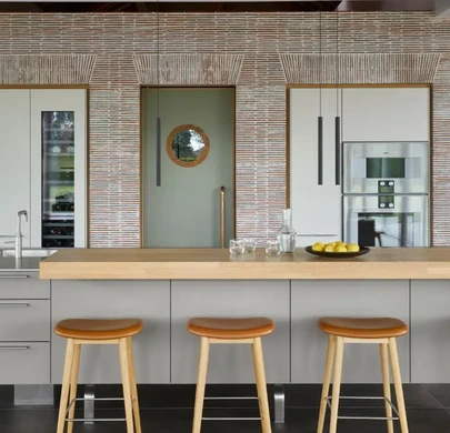 Creased tile feature wall surrounding integrated kitchen appliances