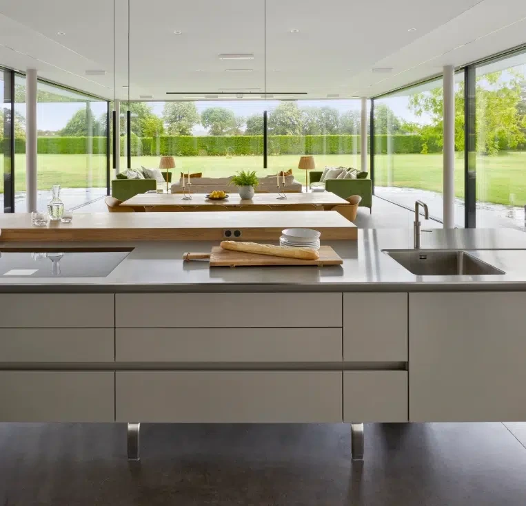 Modern kitchen extension combining grey cabinetry, stainless steel and oak