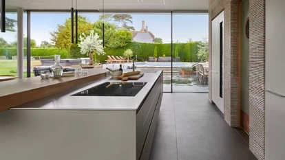 Open-plan bulthaup kitchen island looking onto outdoor poor