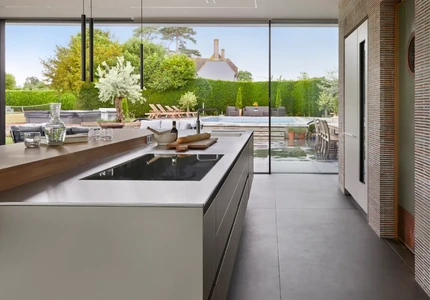 Open-plan bulthaup kitchen island looking onto outdoor poor