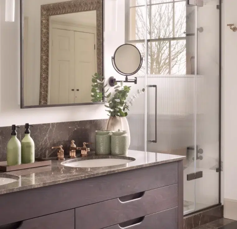 Mirror-fronted bathroom cabinets with integrated storage above double vanity