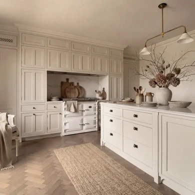 Off-white painted kitchen cabinetry with traditional beaded detailing