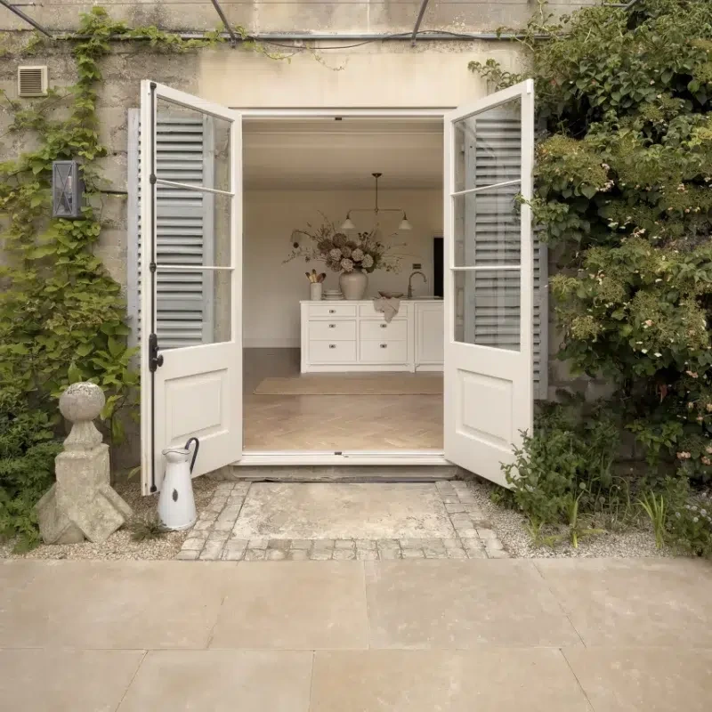 View into a Georgian property through patio doors into the kitchen with a Craftsman's kitchen