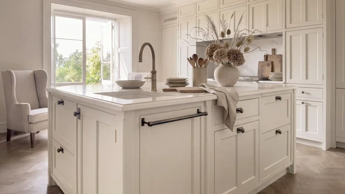 Light-filled kitchen island overlooking the garden through period windows
