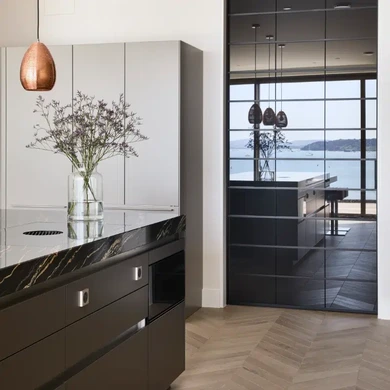 Contemporary kitchen with dark cabinetry and sliding door