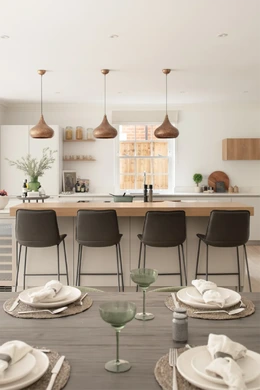 Contemporary new-build kitchen with island seating and natural wood accents