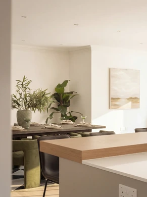 Open plan kitchen and living space with black oak dining table and foliage