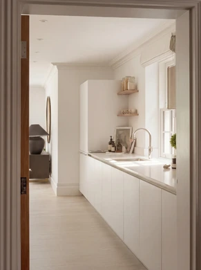 Neutral kitchen with sink facing window and plenty of storage