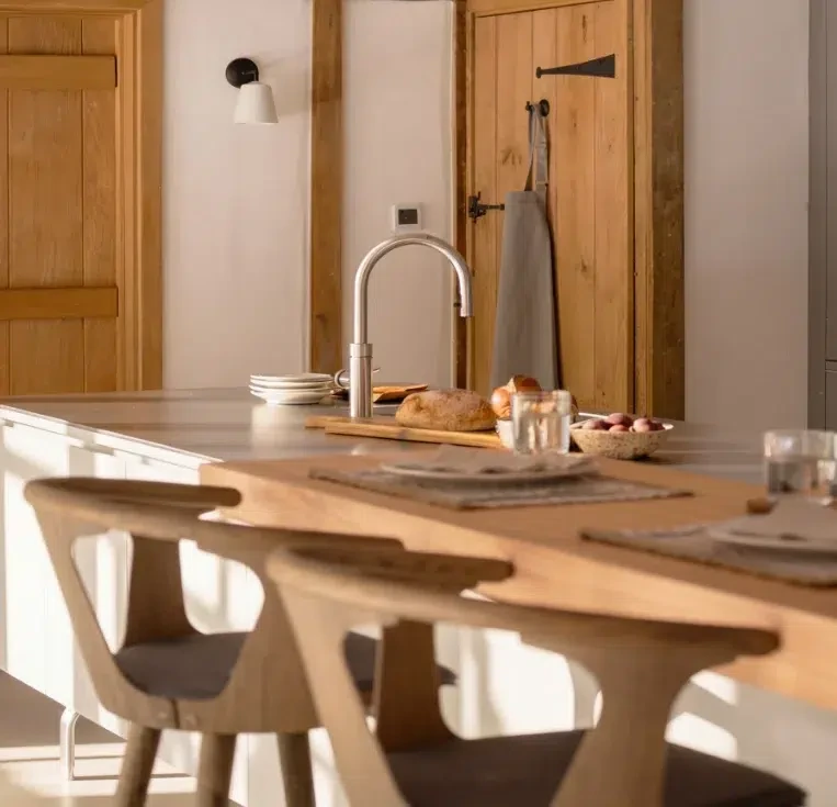 Floating kitchen island with stainless steel worktop and timber breakfast bar