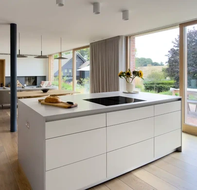 Light-filled kitchen with natural timber and restrained neutral finishes