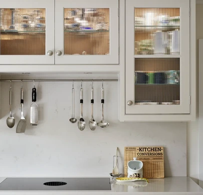 Fluted glass kitchen cabinets with crockery and integrated storage