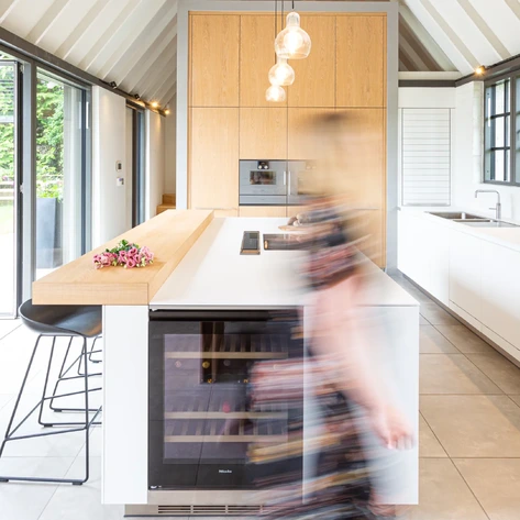 Bright kitchen with full-height glazed doors opening onto the garden