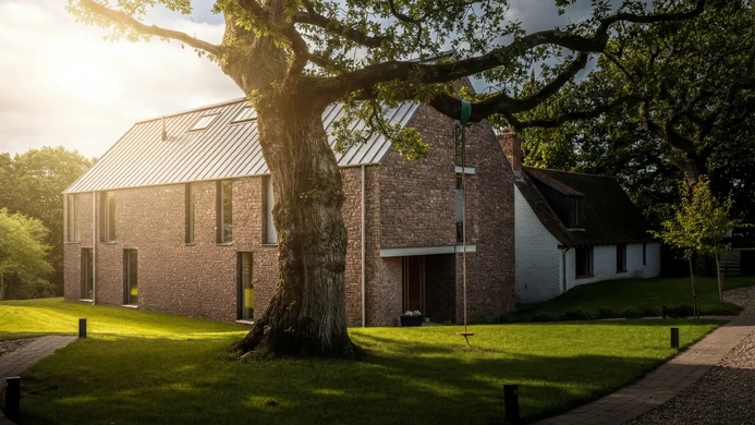 Contemporary barn-style home with stone walls