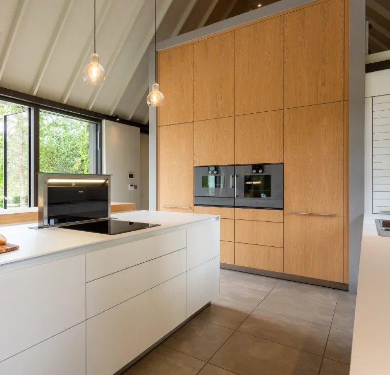 Warm timber kitchen cabinetry with integrated ovens and storage