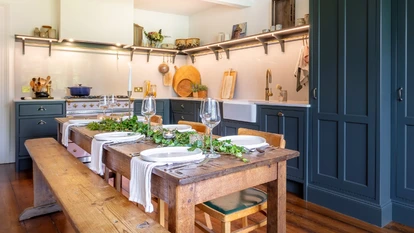 Heritage kitchen cooking area with painted cabinets and open shelving
