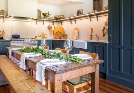 Heritage kitchen cooking area with painted cabinets and open shelving