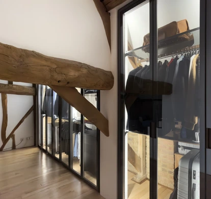Internally illuminated fitted wardrobe with hanging rails, drawers and shelving