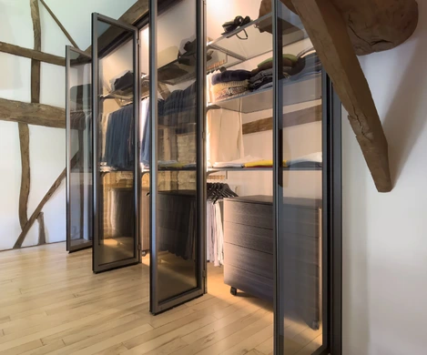Internally illuminated fitted wardrobe with hanging rails, drawers and shelving