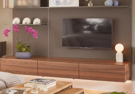 Modern lounge with integrated TV media wall, shelving and walnut cabinetry