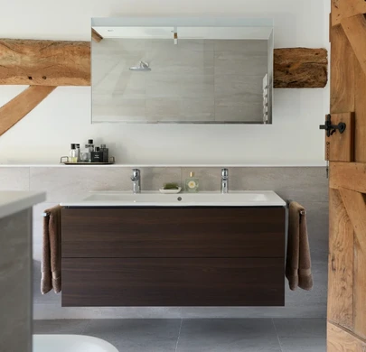 Bespoke double vanity unit with mirrored cabinets in a Cotswold ensuite