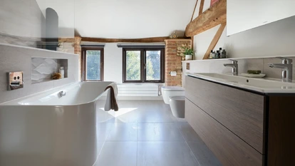 Spacious master ensuite with freestanding bath, double vanity and exposed timber beams