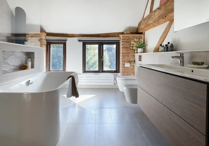 Spacious master ensuite with freestanding bath, double vanity and exposed timber beams
