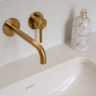 Brass and herringbone ensuite