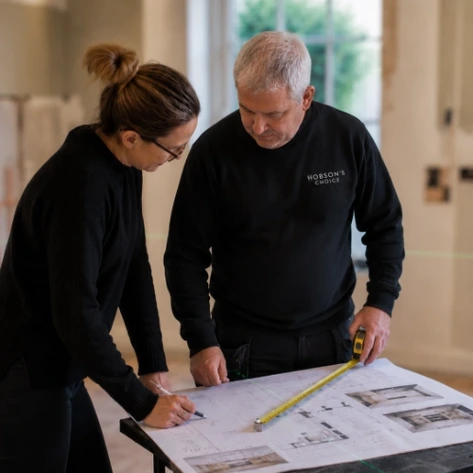 Designer talking Installer through plans for the bathroom