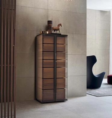 Tall Rimadesio Ala display cabinet with reflective glass doors and timber drawer fronts in a pale contemporary interior.