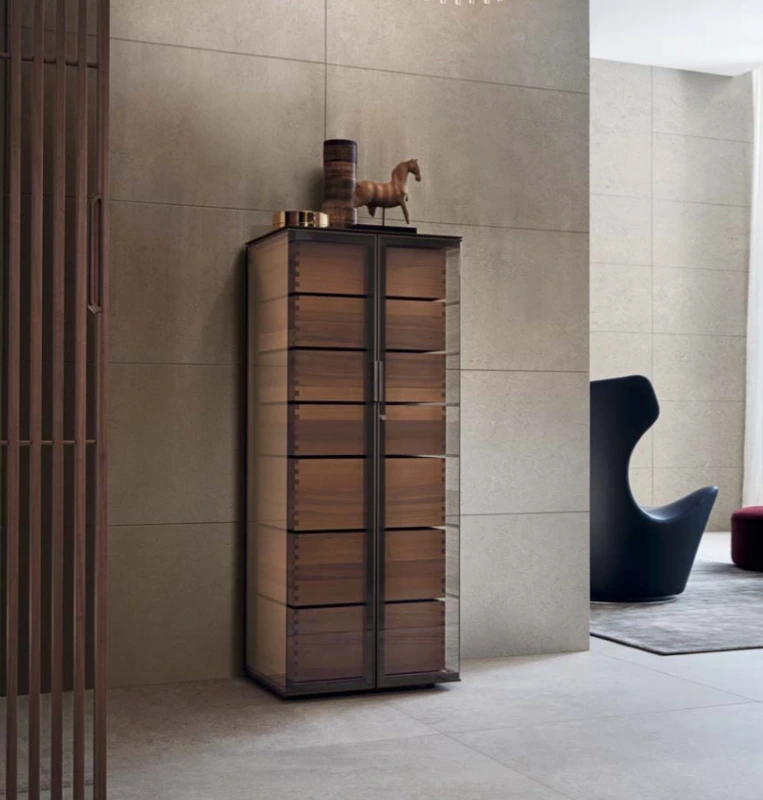 Tall Rimadesio Ala display cabinet with reflective glass doors and timber drawer fronts in a pale contemporary interior.