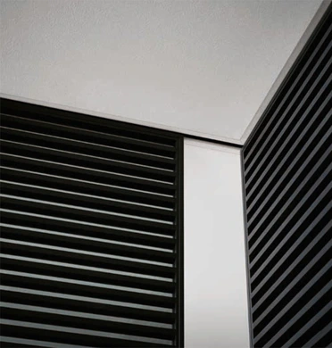 Close-up of black Rimadesio Stripe sliding door panels opening onto a furnished living area
