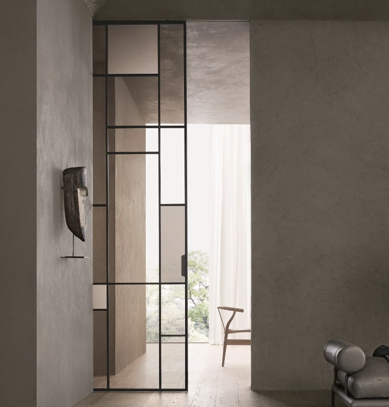 Close-up of timber handles on fluted-glass Rimadesio Maxi sliding door panels.