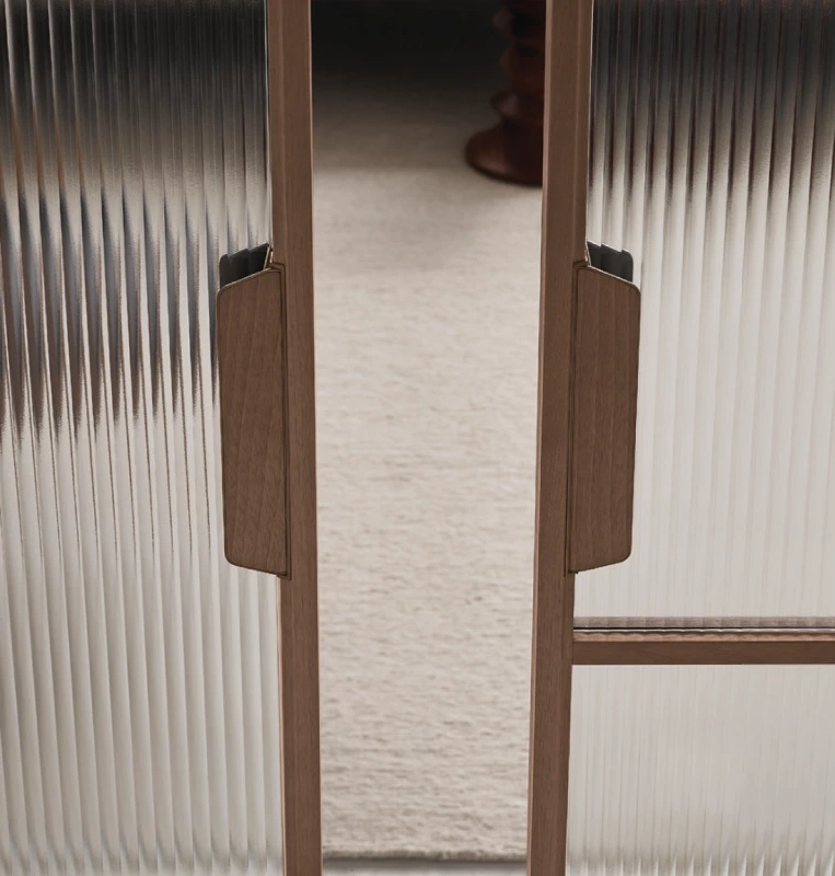 Rimadesio Maxi sliding door partly open between two rooms, showing its tall irregular grid frame and glass panels.