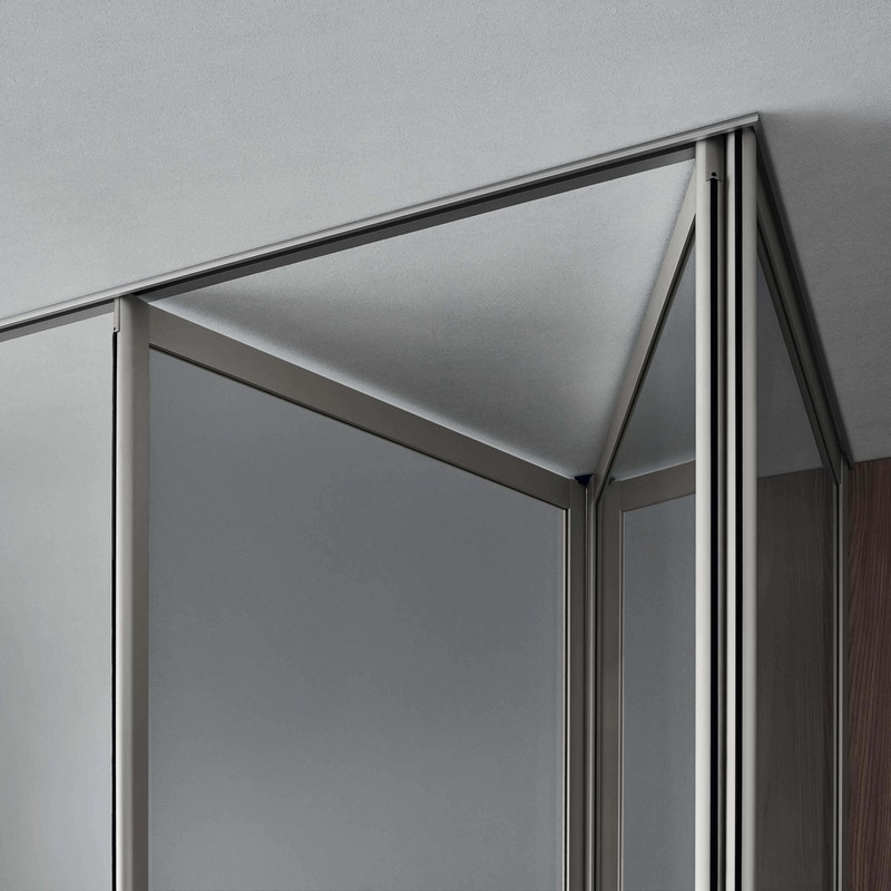 Close-up of the upper corner of a Rimadesio Siparium door, showing the aluminium frame and ceiling rail.