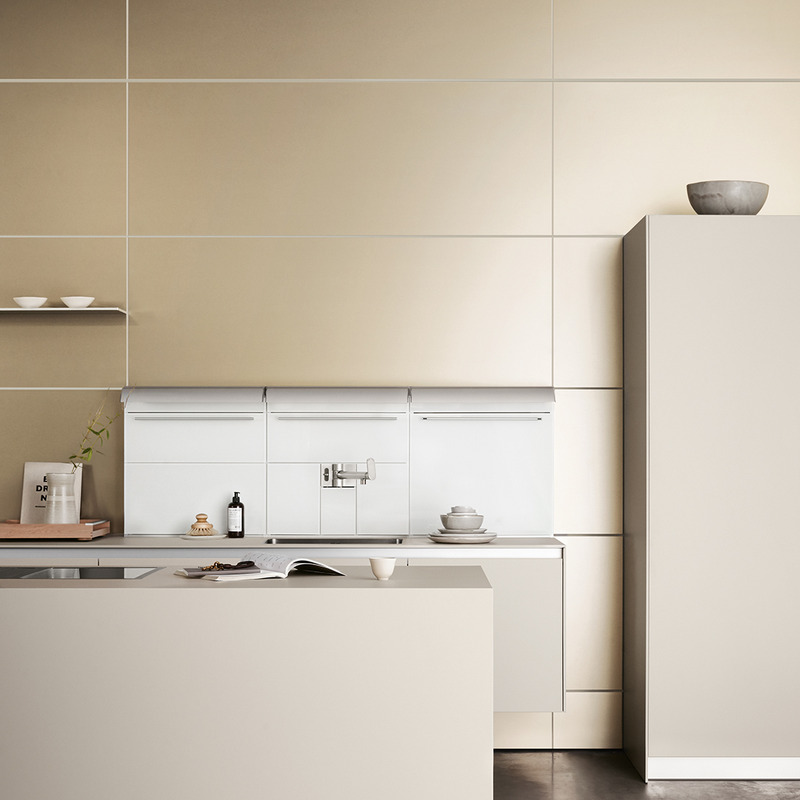 bulthaup b3 kitchen with gold-toned cabinetry and white wall panels