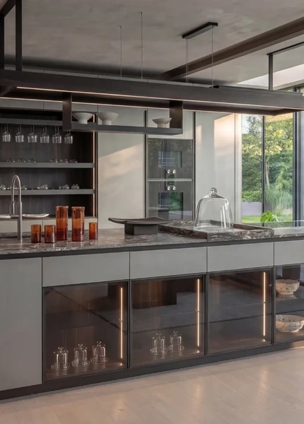 Contemporary Arrital kitchen with a pale island, glazed storage and full-height doors opening to the garden.