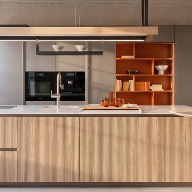 alt="light Arrital Kitchen against a large window and full-hight cabinetry"