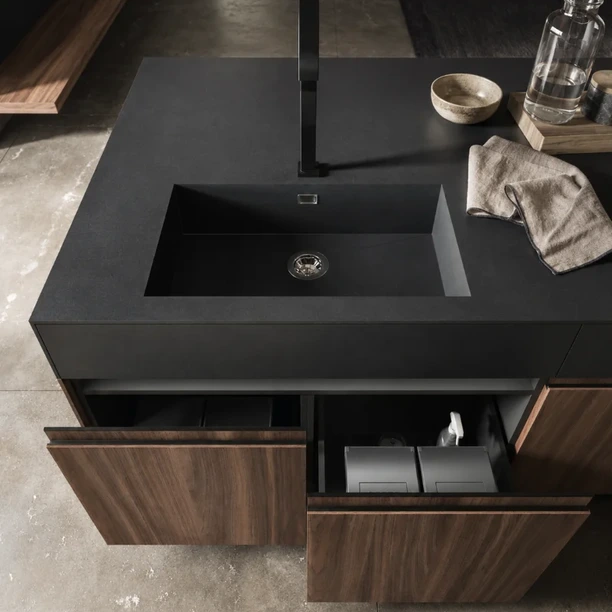 Arrital kitchen island with fluted timber fronts and a pale stone worktop.